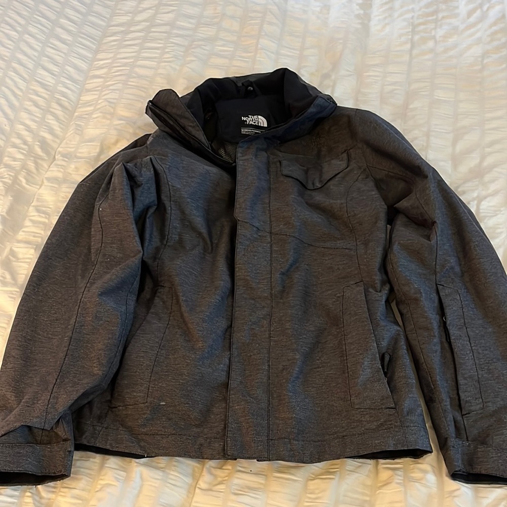 North face outer jacket for ski jacket. With glasses cleaner in sleeve